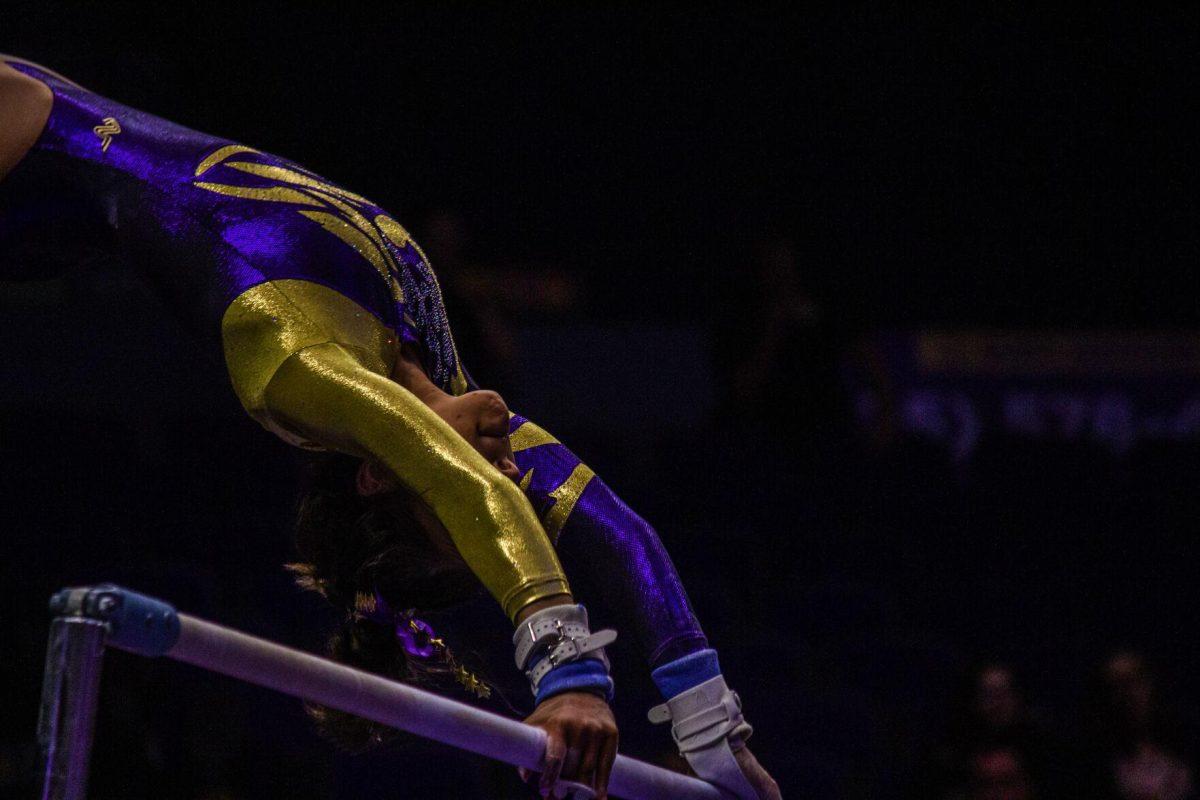 LSU gymnastics senior vault/ balance beam Kamryn Ryan hangs onto a bar Monday, Dec. 12, 2022, during the annual "Gym 101" showcase in the Pete Maravich Assembly Center.