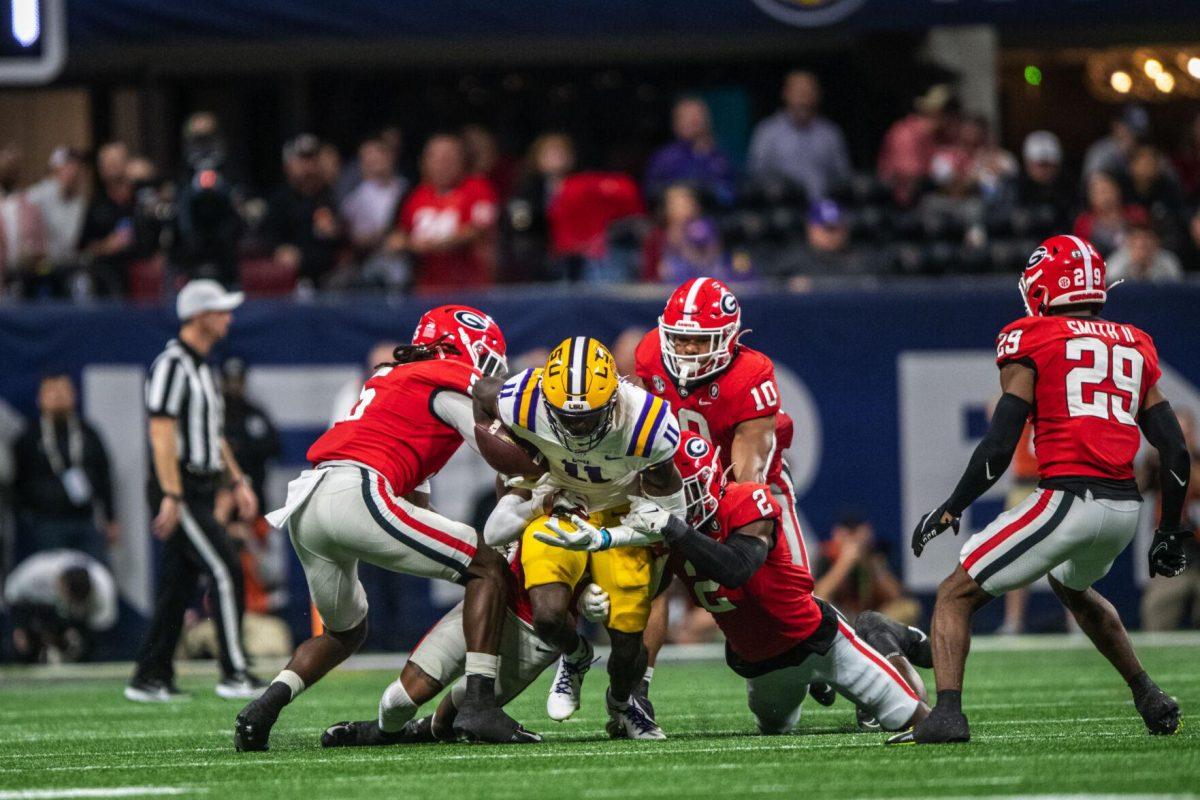 LSU football sophomore wide receiver Brian Thomas (11) bursts through the Georgia defense Saturday, Dec. 3, 2022, during LSU's 30-50 defeat to Georgia at the Southeastern Conference Championship at the Mercedes-Benz Stadium in Atlanta, Georgia.