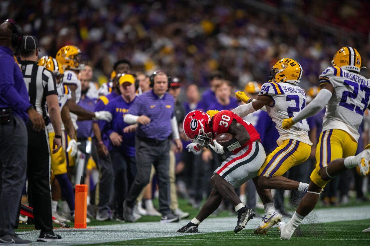 LSU football senior cornerback Jarrick Bernard-Converse (24) pushes Georgia junior tailback Daijun Edwards (30) out of bounds Saturday, Dec. 3, 2022, during LSU's 30-50 defeat to Georgia at the Southeastern Conference Championship in the Mercedes-Benz Stadium in Atlanta, Georgia.