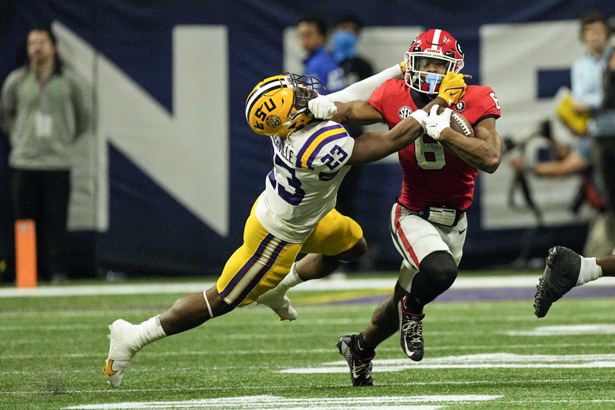 LSU linebacker Micah Baskerville (23) drags Georgia running back Kenny McIntosh (6) down in the second half of the Southeastern Conference Championship football game Saturday, Dec. 3, 2022 in Atlanta. (AP Photo/John Bazemore)