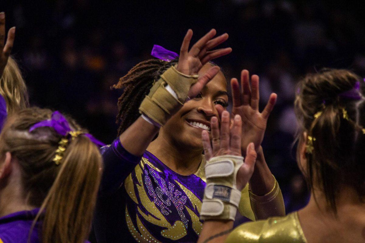 LSU gymnastics freshman all-around Bryce Wilson celebrates her first floor routine with her teammates Monday, Dec. 12, 2022, during the annual "Gym 101" showcase in the Pete Maravich Assembly Center.
