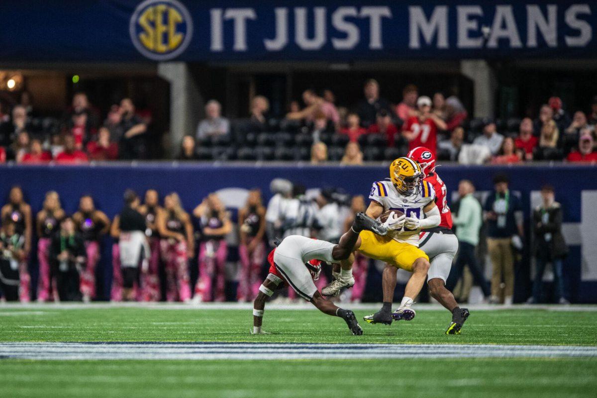 LSU football sophomore wide receiver Jack Bech (80) falls onto Georgia defenders after completing a pass Saturday, Dec. 3, 2022, during LSU's 30-50 defeat to Georgia at the Southeastern Conference Championship at the Mercedes-Benz Stadium in Atlanta, Georgia.