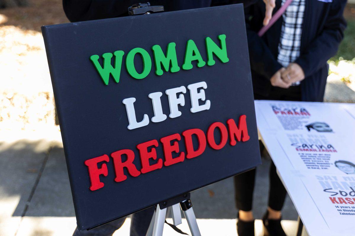 A sign reading "Woman Life Freedom," a symbol of anti-government protests in Iran sits Wednesday, Nov. 30, 2022, in Free Speech Plaza.