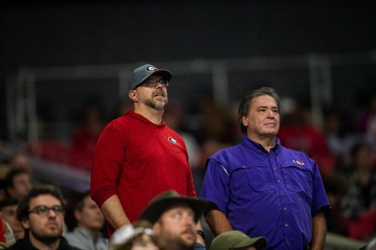 A Georgia fan and a LSU fan watch the game together Saturday, Dec. 3, 2022, during LSU's 30-50 defeat to Georgia at the Southeastern Conference Championship in the Mercedes-Benz Stadium in Atlanta, Georgia.