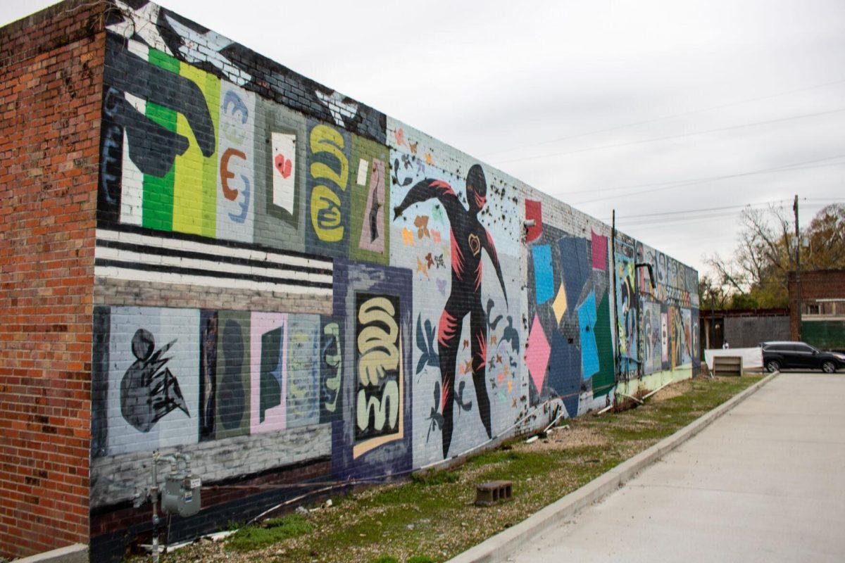 A painted mural lines a building on Friday, Dec 2, 2022, on Government St in downtown Baton Rouge, La.