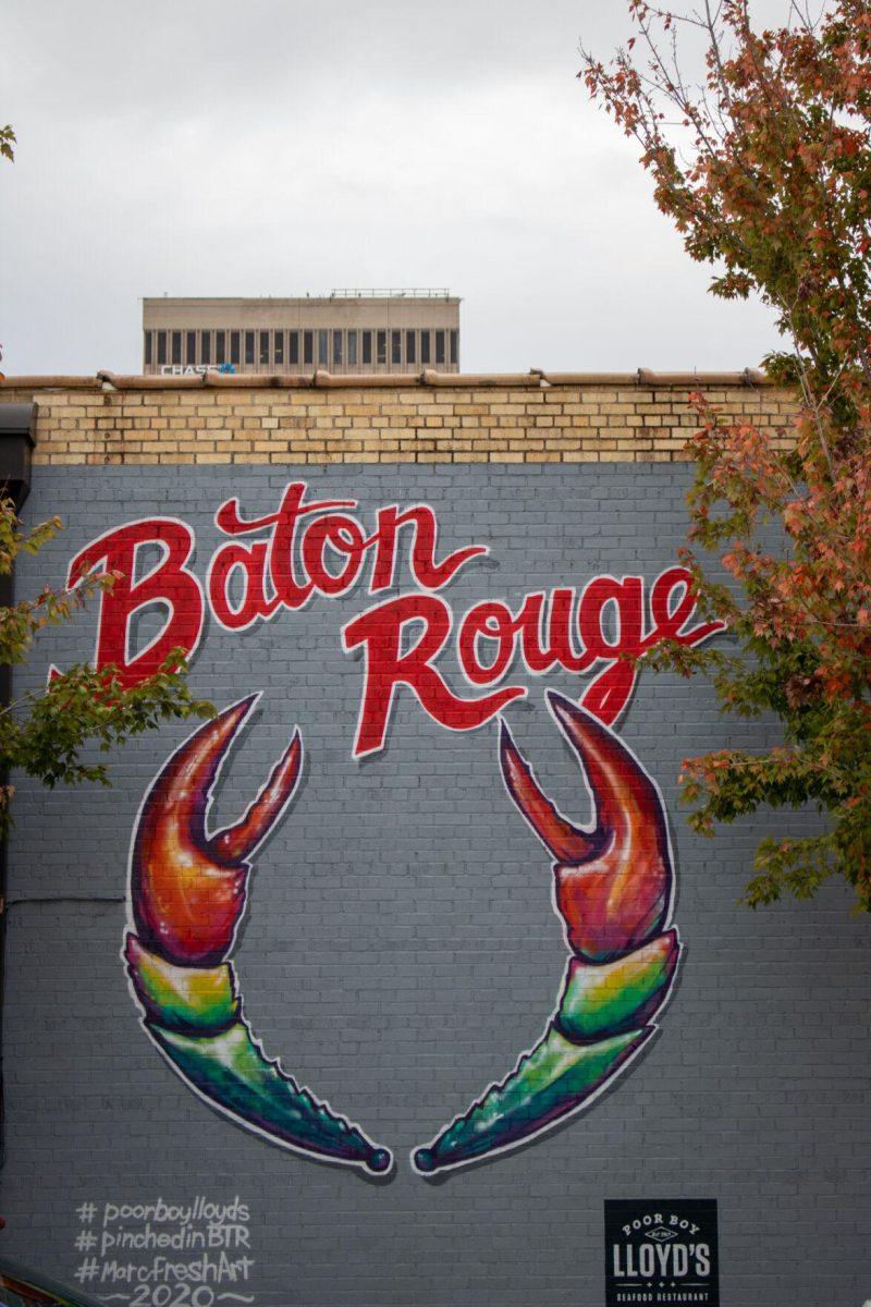 A mural sits between two trees on Friday, Dec 2, 2022, on Lafayette St. in downtown Baton Rouge, La.