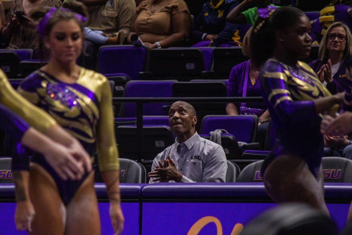 LSU president William Tate applauds the LSU gymnastics team Monday, Dec. 12, 2022, during the annual "Gym 101" showcase in the Pete Maravich Assembly Center.