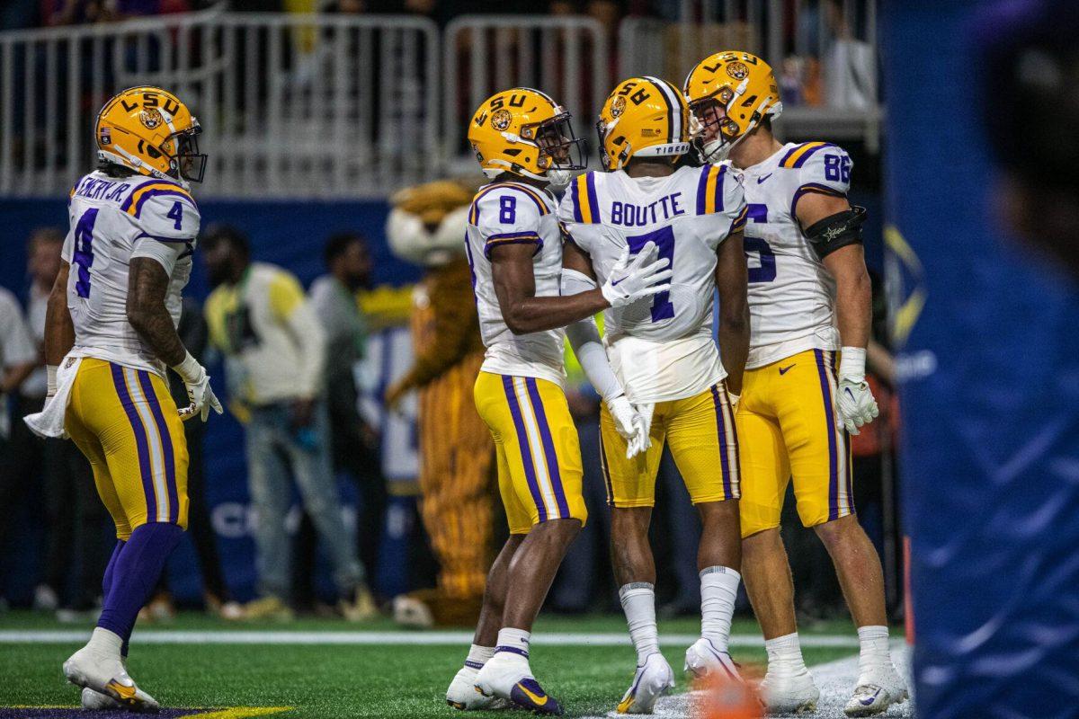 LSU football junior wide receiver Kayshon Boutte (7) celebrates with teammates Saturday, Dec. 3, 2022, after scoring a touchdown during LSU's 30-50 defeat to Georgia at the Southeastern Conference Championship at the Mercedes-Benz Stadium in Atlanta, Georgia.