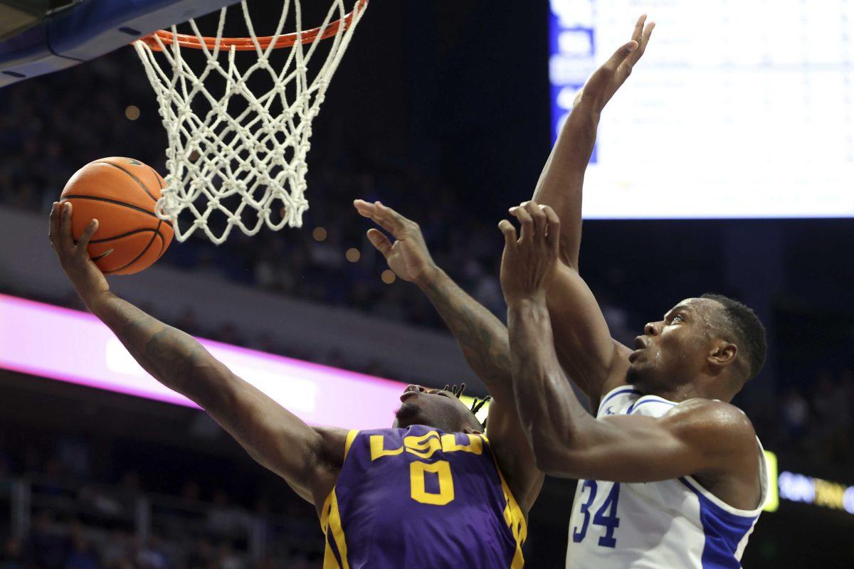 Kentucky's Oscar Tshiebwe (34) pressures LSU's Trae Hannibal (0) during the second half of an NCAA college basketball game in Lexington, Ky., Tuesday, Jan. 3, 2023. Kentucky won 74-71. (AP Photo/James Crisp)