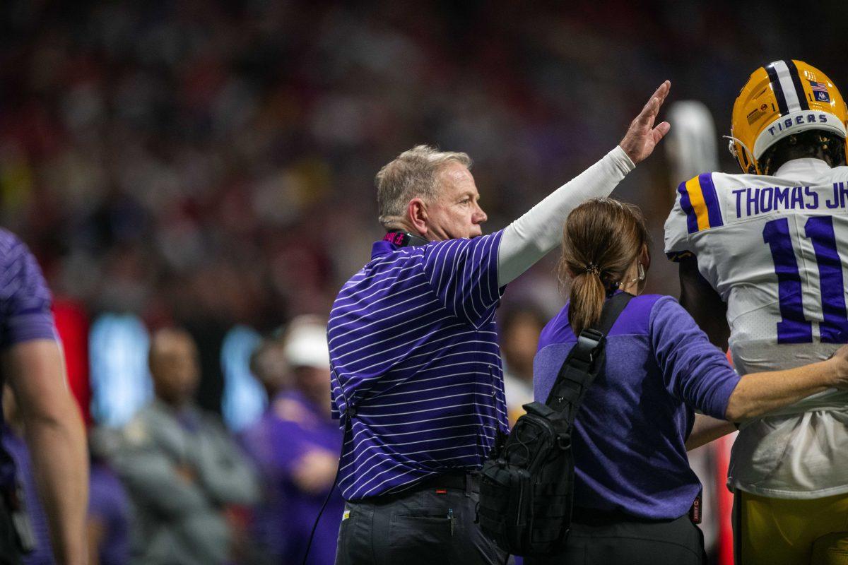 LSU football head coach Brian Kelly taps sophomore wide receiver Brian Thomas Jr. (11)'s helmet after he comes off injured Saturday, Dec. 3, 2022, during LSU's 30-50 defeat to Georgia at the Southeastern Conference Championship in the Mercedes-Benz Stadium in Atlanta, Georgia.