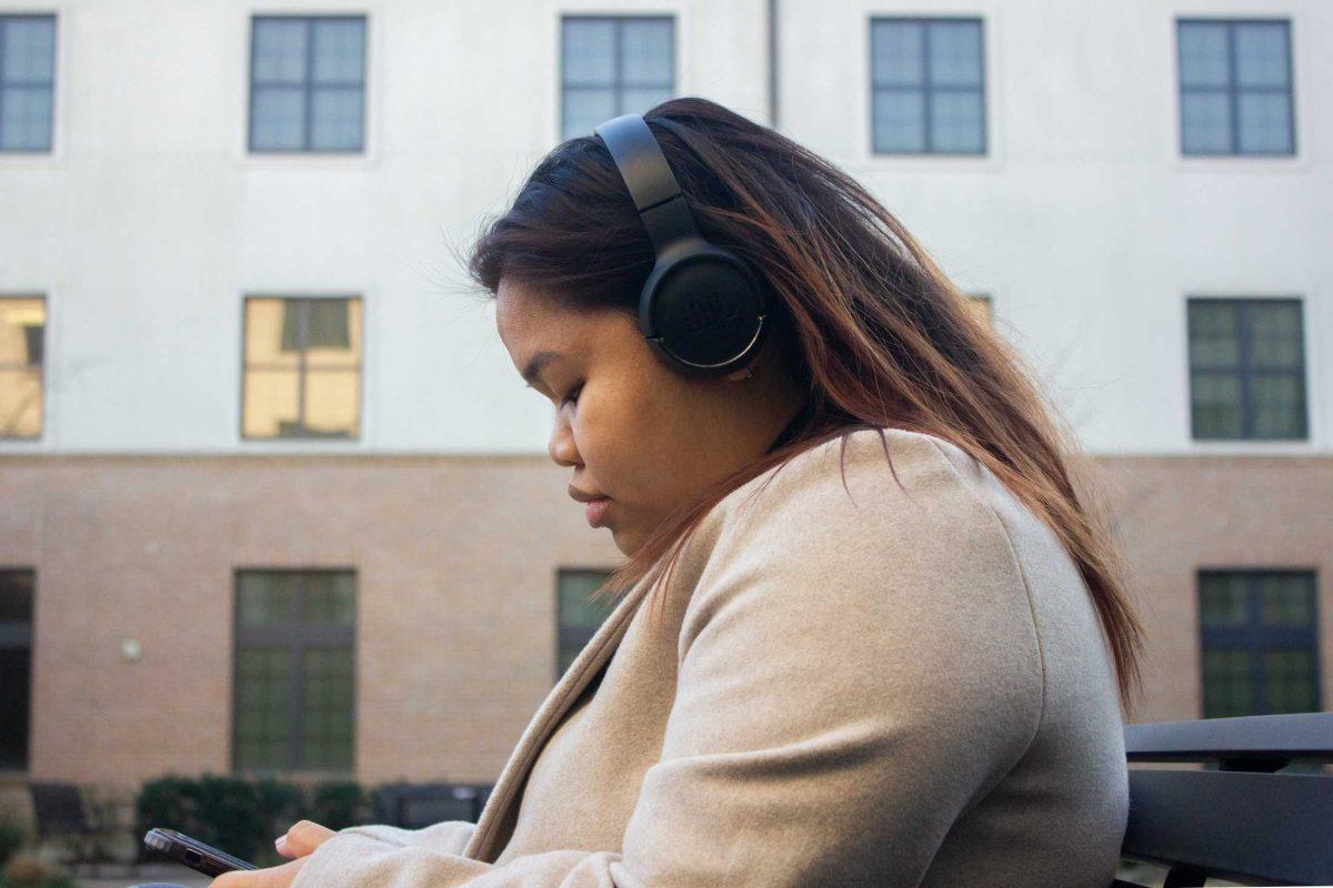 LSU biological sciences freshman Maya Lazo scrolls on her phone on Thursday, Jan. 26, 2023, in the courtyard of Spruce Hall in Baton Rouge, La.