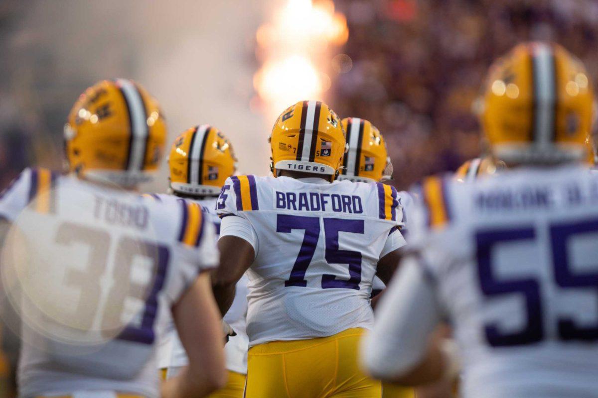 <p>Offensive line Anthony Bradford (75) jogs onto the field with his teammates while fireworks shower the sky on Saturday, Nov. 5, 2022, during LSU’s 32-31 victory over Alabama in Tiger Stadium in Baton Rouge, La.</p>