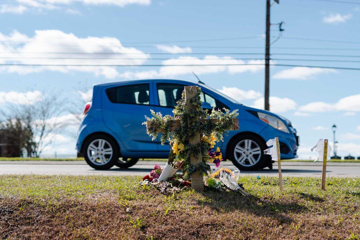 A car passes the memorial set up for Madison Brooks on Wednesday, Jan. 25, 2023, on Burbank Drive in Baton Rouge, La.