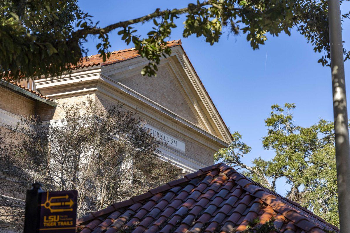 A oak tree branch frames the view of the Journalism Building Thursday, Dec. 1, 2022, on Field House Drive.