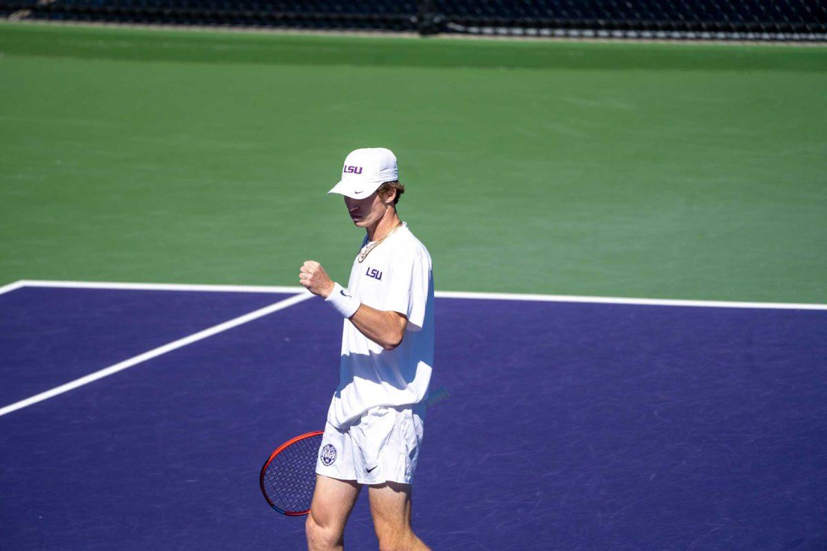 LSU men's tennis junior Welsh Hotard pumps his fist during his 6-2 doubles win against Lamar Sunday, Feb. 12, 2023, at the LSU tennis complex on Gourrier Avenue in Baton Rouge, La.