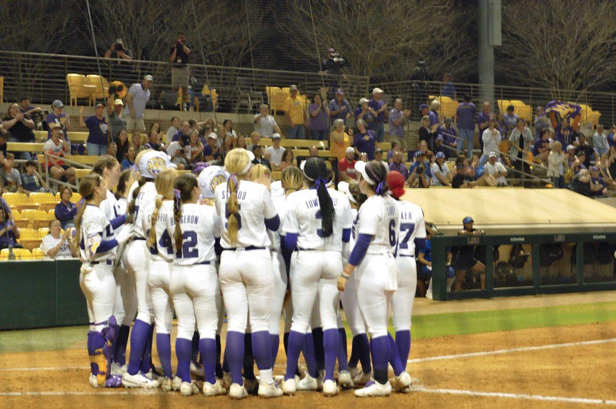 The LSU softball team crowds around home plate after graduate infielder Georgia Clark (25) hit a home run Friday, Feb. 24, 2023, during LSU's 11-0 win against Texas A&amp;M - Corpus Christi at Tiger Park in Baton Rouge.