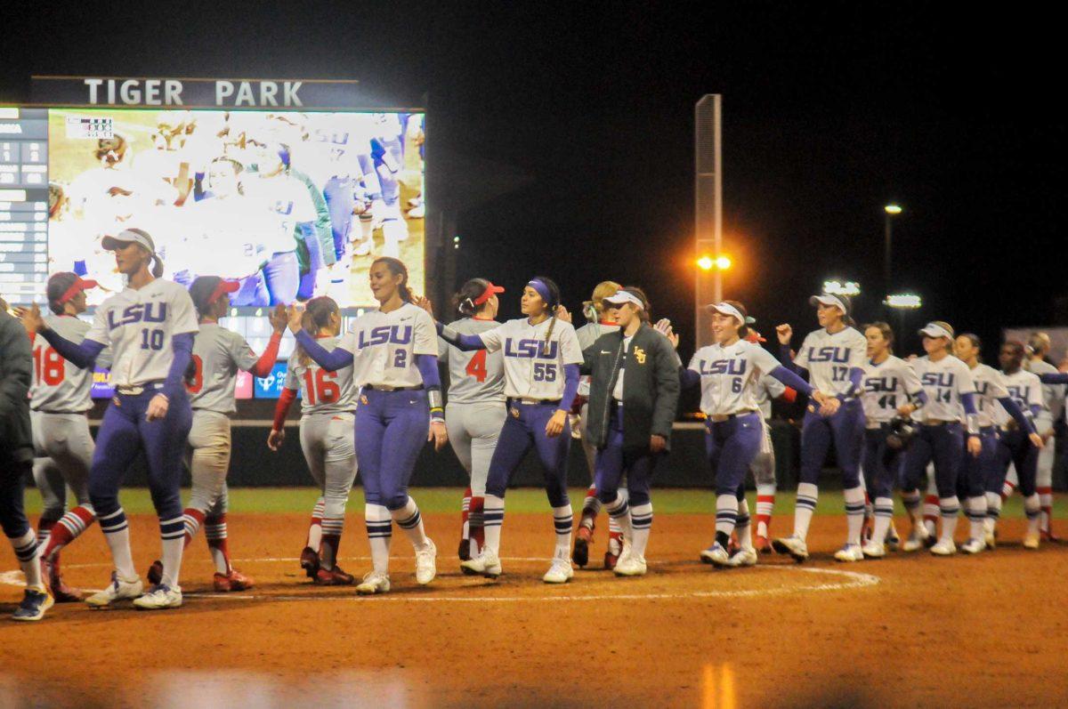 The LSU softball team shakes hands with New Mexico Friday, Feb. 10, 2023, during LSU's 11-3 win against New Mexico at Tiger Stadium on Skip Bertman Dr. in Baton Rouge