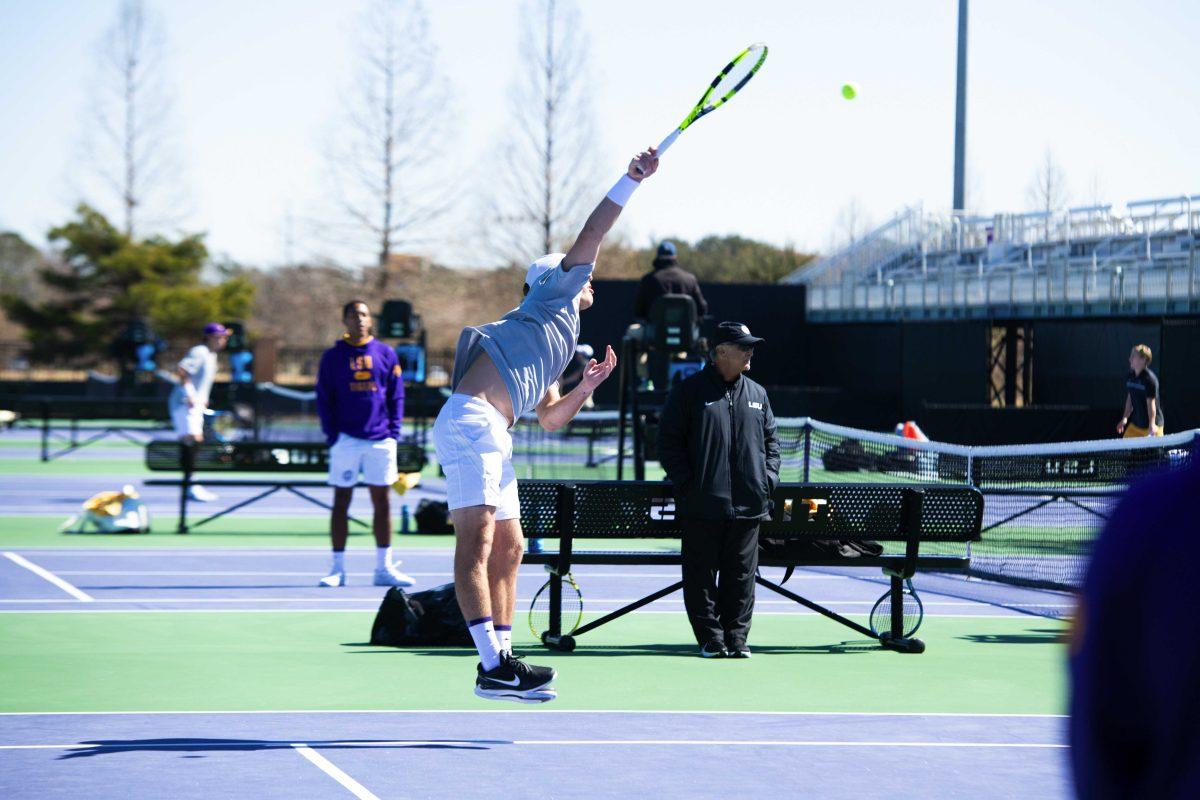 LSU men's tennis junior Nick Watson jumps up as he serves the ball Sunday, Feb. 13, 2021 during LSU's 6-1 win over Purdue at the LSU Tennis Complex on Gourrier Avenue in Baton Rouge, La.