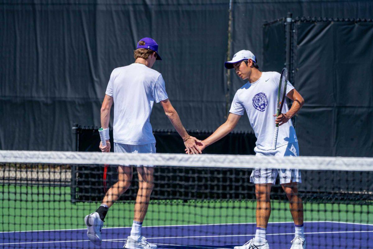 LSU men's tennis junior Welsh Hotard and Chen Dong celebrate a point during their 6-4 doubles win against ULL Sunday, Feb. 26, 2023, at the LSU tennis complex on Gourrier Avenue in Baton Rouge, La.