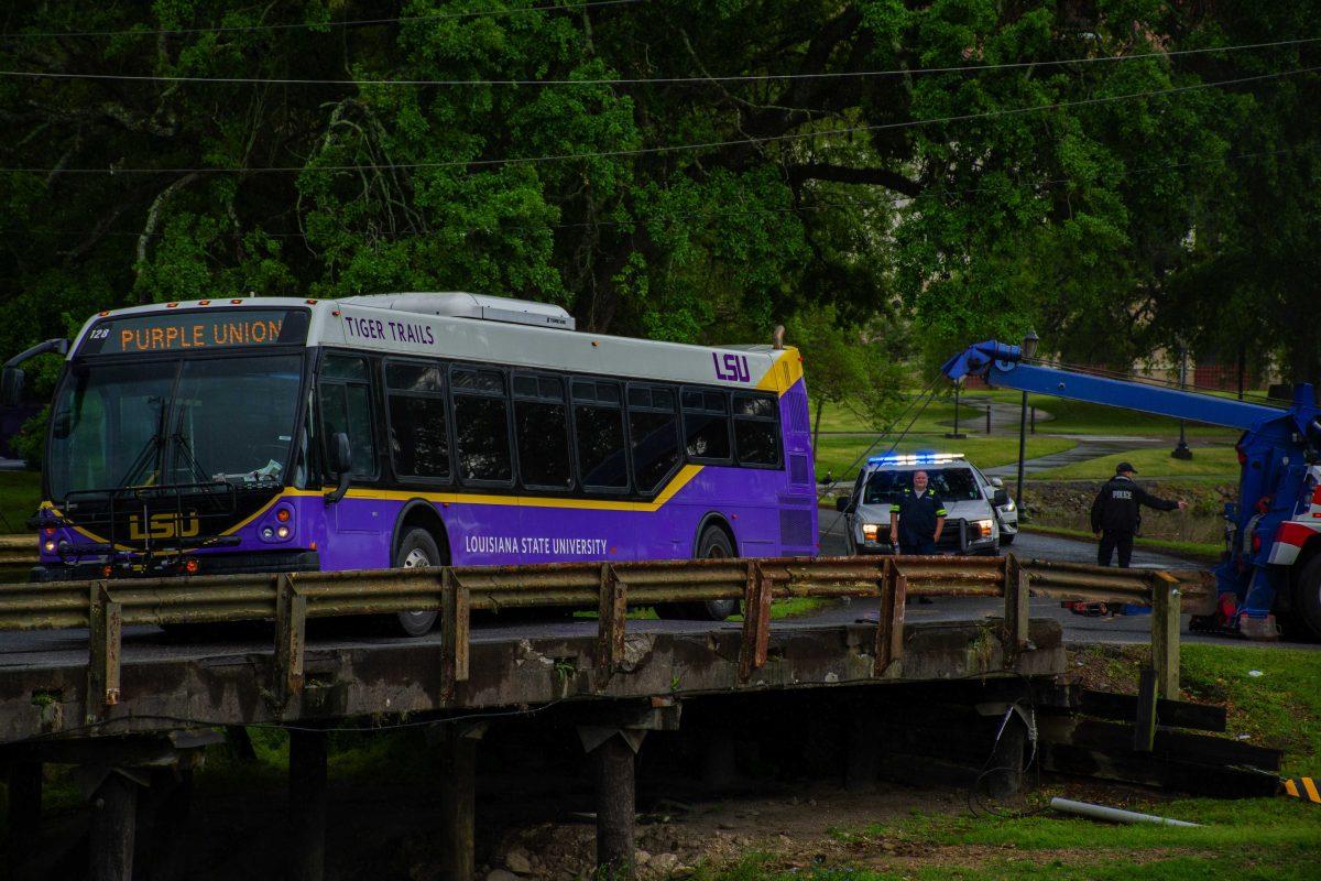 A tiger trails bus is teetering over University Lakes Monday, April 11, 2022, on W Lakeshore Drive at LSU in Baton Rouge, La.