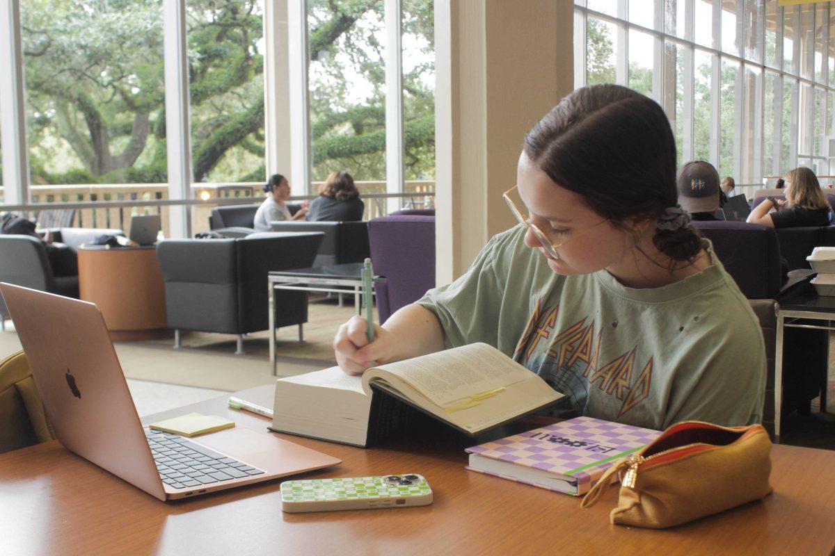 Student reading and writing in her book while studying on Friday, Aug. 26, 2022, in the Student Union on LSU's Campus in Baton Rouge, La.