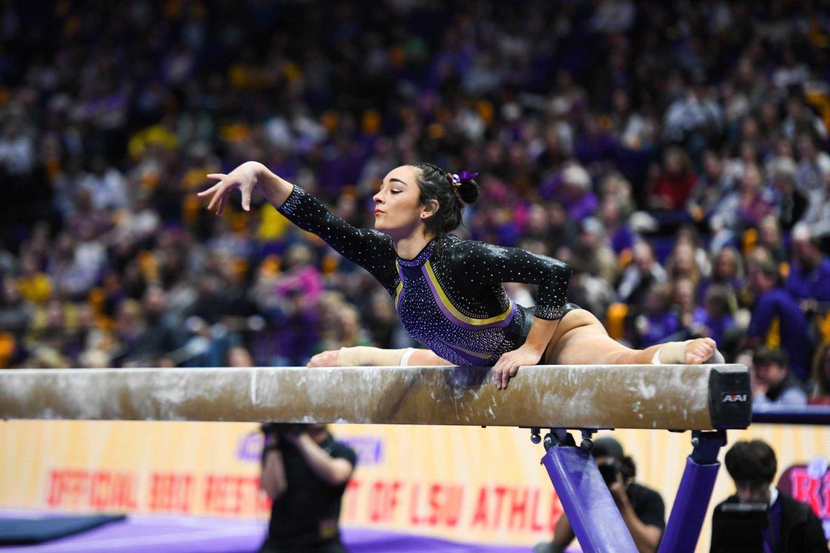 <p>LSU gymnastics all-around junior Elena Arenas strikes a pose on the balance beam Friday, Feb. 17, 2023, during LSU’s 198.100-197.975 victory over Florida in the Pete Maravich Assembly Center in Baton Rouge, La.</p>