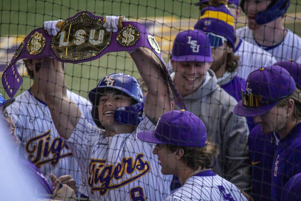 LSU baseball graduate student infield/ outfield Gavin Dugas (8) holds up a LSU belt Saturday, Feb. 18, 2023, after his home run during LUS's 5-3 victory over Western Michigan at Alex Box Stadium on LSU's campus.