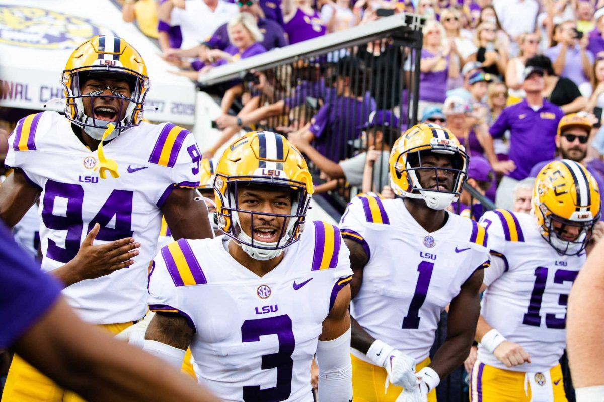 LSU football freshman defensive end Princeton Malbrue (94), senior safety Greg Brooks Jr. (3), and graduate student cornerback Sevyn Banks (1) excitedly ran onto the field Saturday, Sept. 17, 2022 before LSU&#8217;s 31-16 win against Mississippi State at Tiger Stadium in Baton Rouge, La.