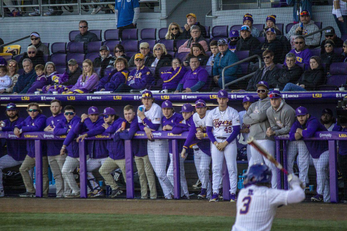 The LSU baseball dugout watches junior outfielder Dylan Crews (3) gears up to strike the ball Saturday, Feb. 18, 2023, during LSU's 5-3 victory over Western Michigan at Alex Box Stadium on LSU's campus.