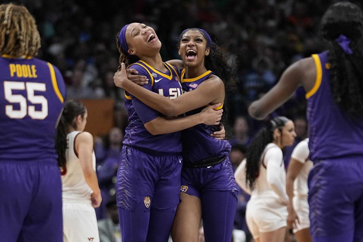 LSU's Angel Reese and LaDazhia Williams react during the second half of an NCAA Women's Final Four semifinals basketball game against Virginia Tech Friday, March 31, 2023, in Dallas. (AP Photo/Tony Gutierrez)