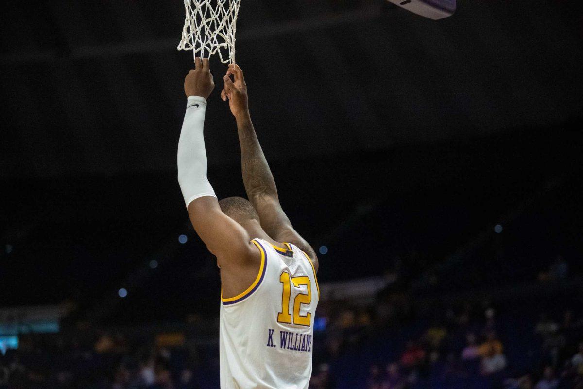 LSU men&#8217;s basketball 5th-year-senior forward KJ Williams (12) hangs onto the net on Wednesday, March 1, 2023, during LSU&#8217;s 81-76 loss against Missouri in the Pete Maravich Assembly Center in Baton Rouge, La.