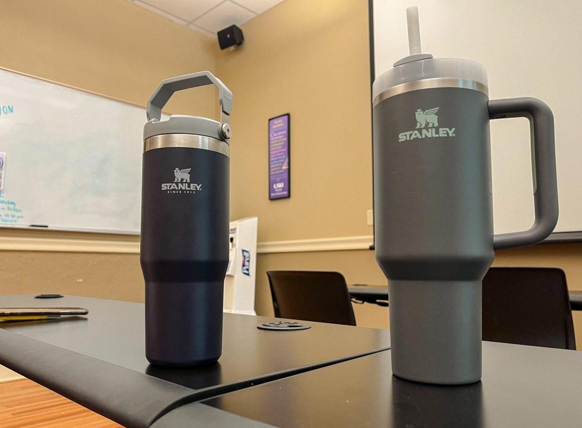 Mass communication sophomore Jenna Bridges' black 30 ounce Stanley water bottle sits beside mass communication junior Ashlyn Pinsonat's gray 40 ounce Stanley water bottle water bottle in a classroom of the Manship School on Feb. 28, 2023. Pinsonat said she had two Stanley bottles so she could always be using one, even if the other was in the dishwasher.