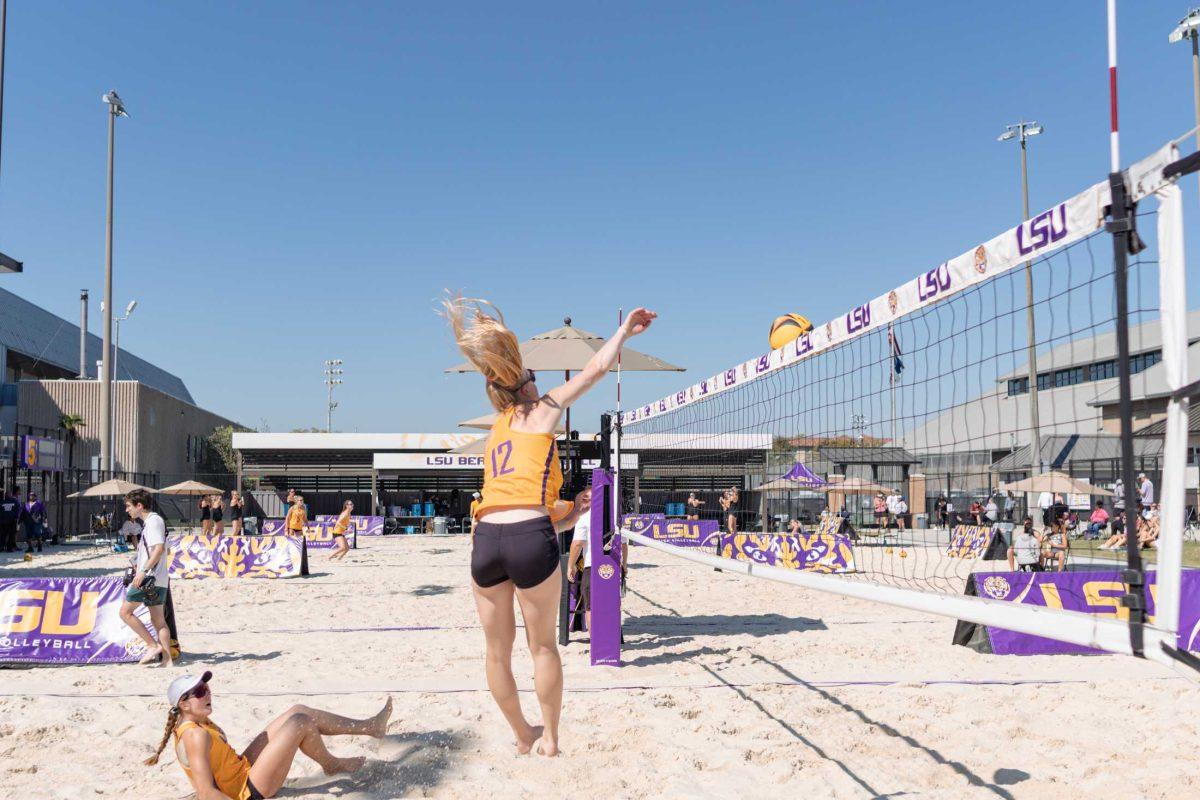 LSU beach volleyball junior Amber Hayes (12) hits the ball over the net on Sunday, March 5, 2023, during LSU&#8217;s 5-0 win against North Alabama at the Beach Volleyball Stadium on Cypress Drive in Baton Rouge, La.