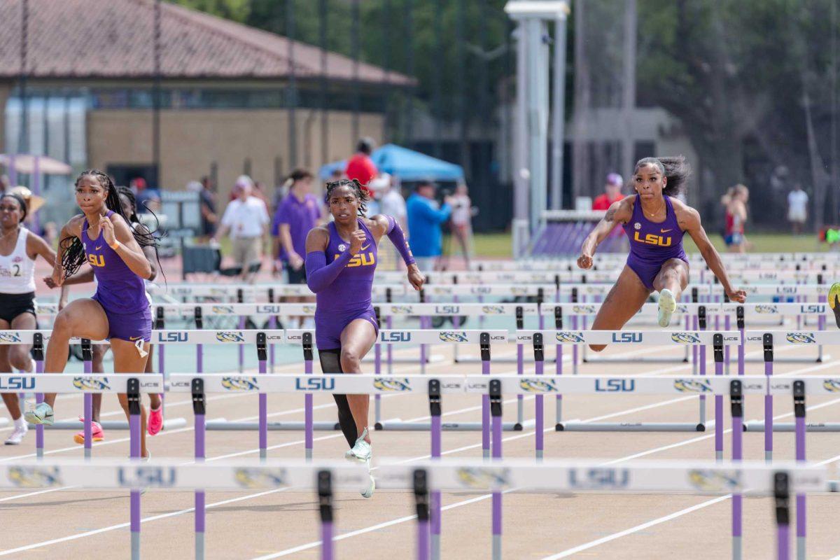 LSU track and field junior sprinters Leah Phillips (left), Alia Armstrong (center) and Shani&#8217;a Bellamy (right) compete in the 100-meter hurdles on Saturday, March 25, 2023, during the Battle on the Bayou track meet at the Bernie Moore Track Stadium in Baton Rouge, La.