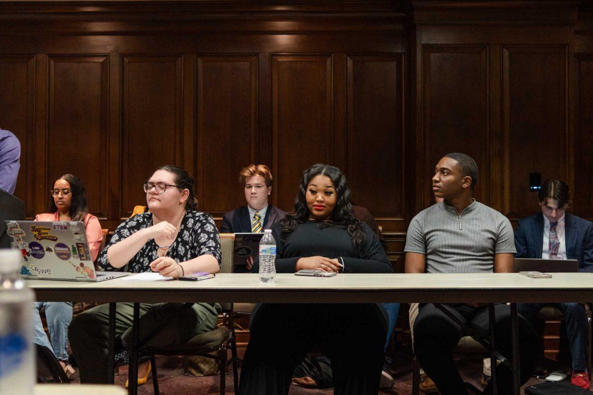 Inspire candidates Amber Salone (center) and Byron Hansley (right) and their council Alex Basse (left) listen to the arguments presented on Monday, Feb. 27, during a Student Government judicial proceeding in the LSU Student Union on Highland Road in Baton Rouge, La.