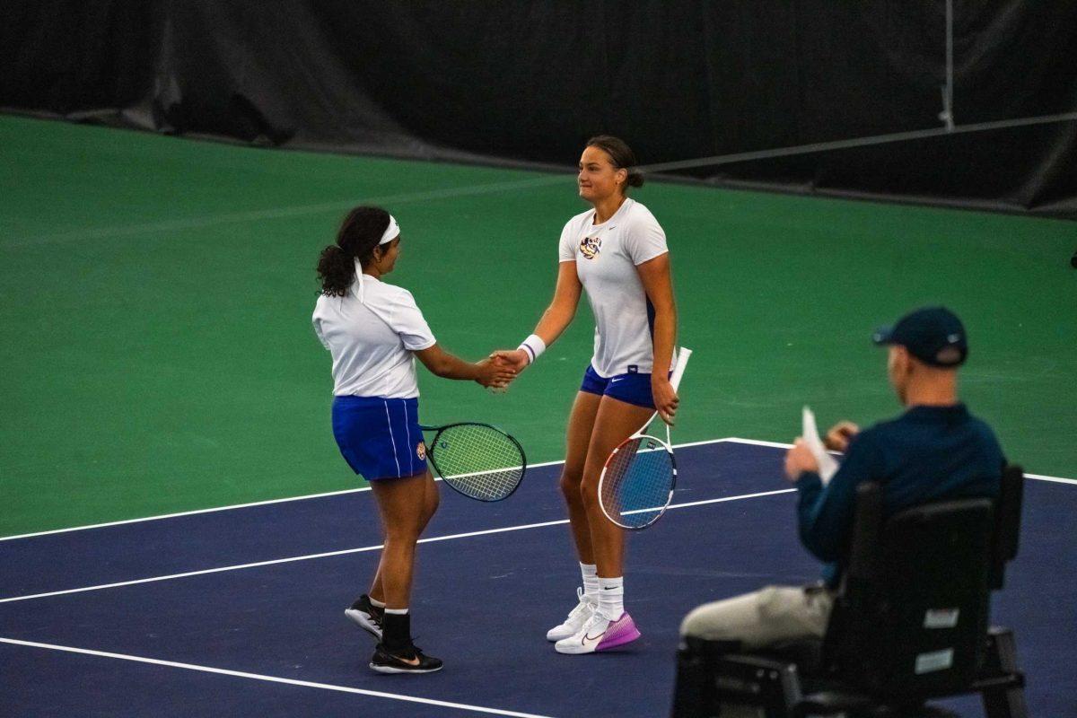 LSU women's tennis redshirt freshman Anastasiya Komar and freshman Nikita Vishwase shake hands after a point during their 6-1 doubles win against Alcorn on Monday, March 20, 2023, at the LSU tennis complex on Gourrier Avenue in Baton Rouge, La.