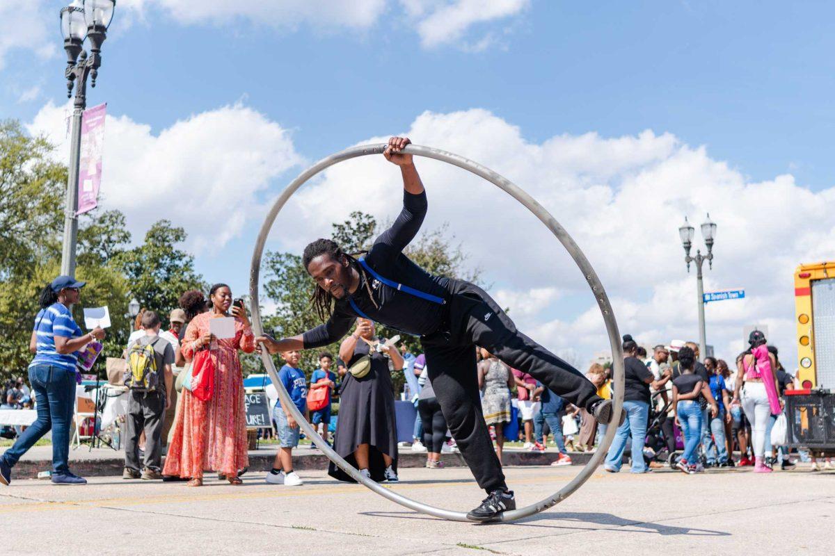 A man performs in a spinning ring on Saturday, Feb. 25, 2023, at 225 Fest in Baton Rouge, La.