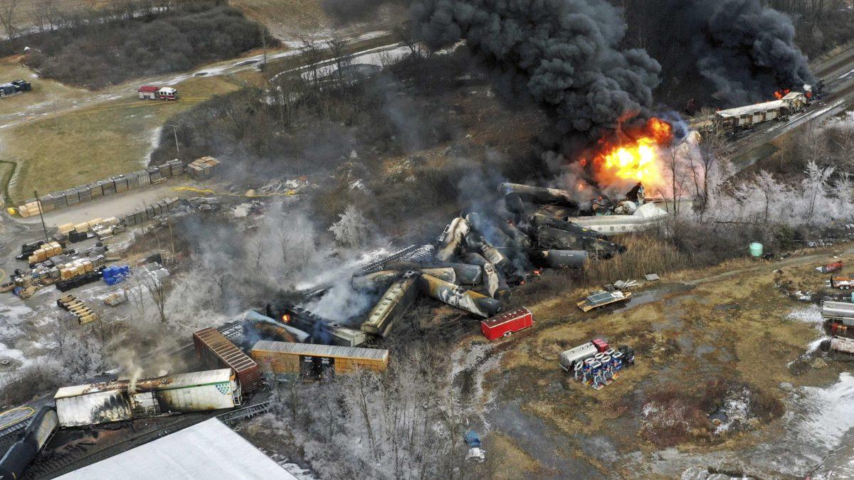 FILE - In this photo taken with a drone, portions of a Norfolk Southern freight train that derailed the previous night in East Palestine, Ohio, remain on fire at mid-day on Feb. 4, 2023. Transportation Secretary Pete Buttigieg announced a package of reforms to improve safety Tuesday, Feb. 21 &#8212; two days after he warned the railroad responsible for the derailment, Norfolk Southern, to fulfill its promises to clean up the mess just outside East Palestine, and help the town recover. (AP Photo/Gene J. Puskar, File)