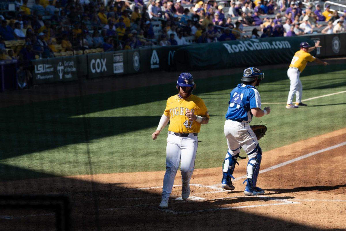 LSU baseball sophomore third baseman Tommy White (47) scores Sunday, March 5, 2023, during LSU baseball's 13-0 victory over Central Connecticut State at Alex Box Stadium in Baton Rouge, La.