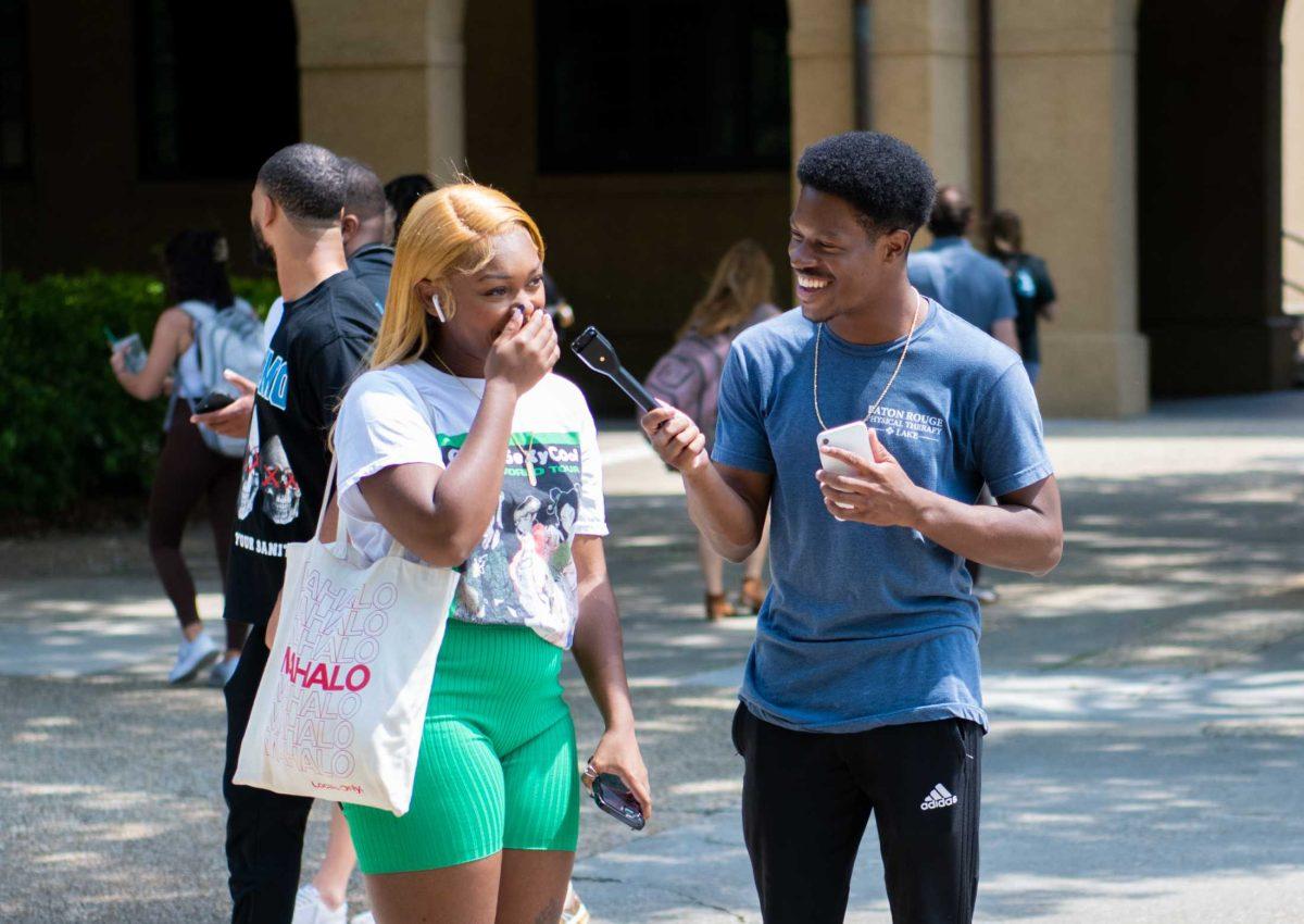 An LSU student and Seth Trotter laugh on Wednesday, April 5, 2023, in the Quad in Baton Rouge, La.