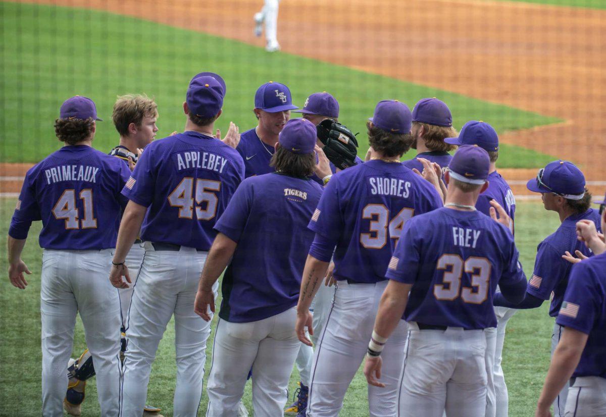 LSU baseball players high five their teammates on Friday, March 24, 2023, during LSU's 3-9 loss against Arkansas in Alex Box Stadium in Baton Rouge, La.