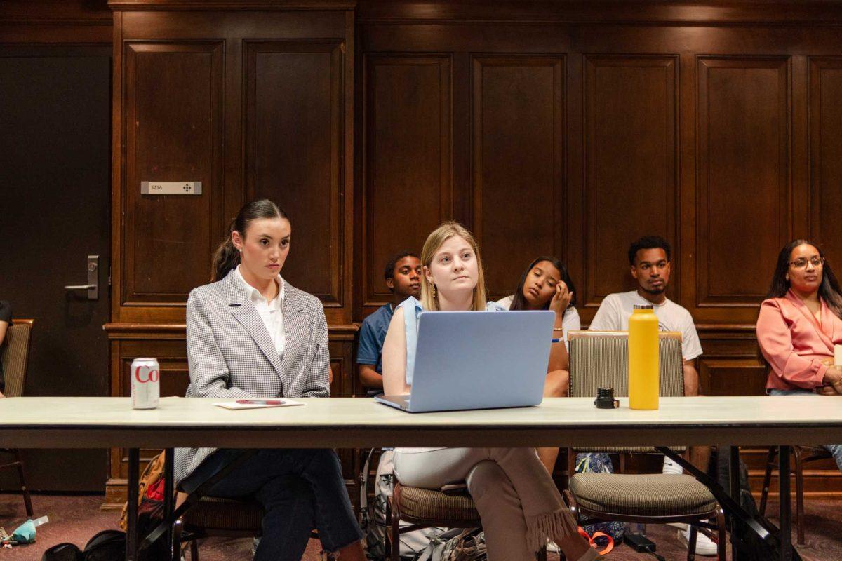 Innovate ticket heads Gigi Powers (left) and Anna Cate Strong (right) listen on Monday, Feb. 27, 2023, during a Student Government judicial proceeding in the LSU Student Union on Highland Road in Baton Rouge, La.