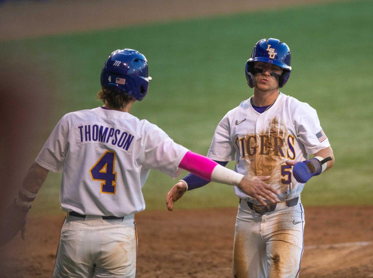 LSU baseball junior infielder Jordan Thompson (4) and LSU baseball junior infielder Ben Nippolt (5) celebrate two runs on Friday, April 14, 2023, during LSU&#8217;s 13-10 loss against Kentucky in Baton Rouge, La.