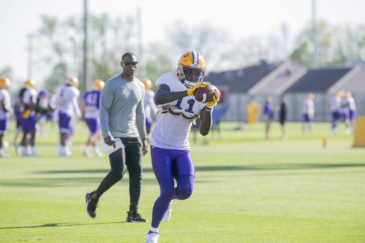 LSU football wide receiver Brian Thomas Jr. (11) passes the ball Thursday, April 7, 2022, during LSU&#8217;s spring practice in Baton Rouge, Louisiana.