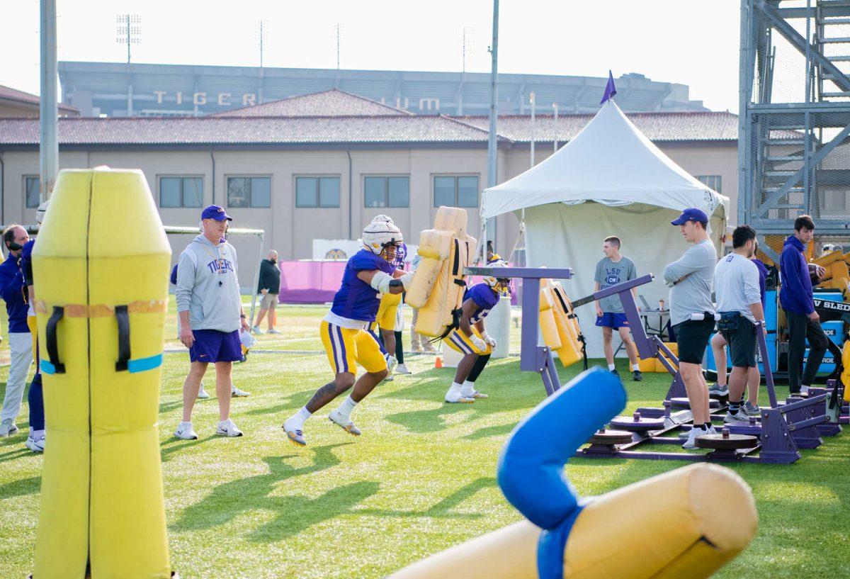 LSU football coaches watch players on Tuesday, April 18, 2023, at the Charles McClendon Practice Facility in Baton Rouge, La.