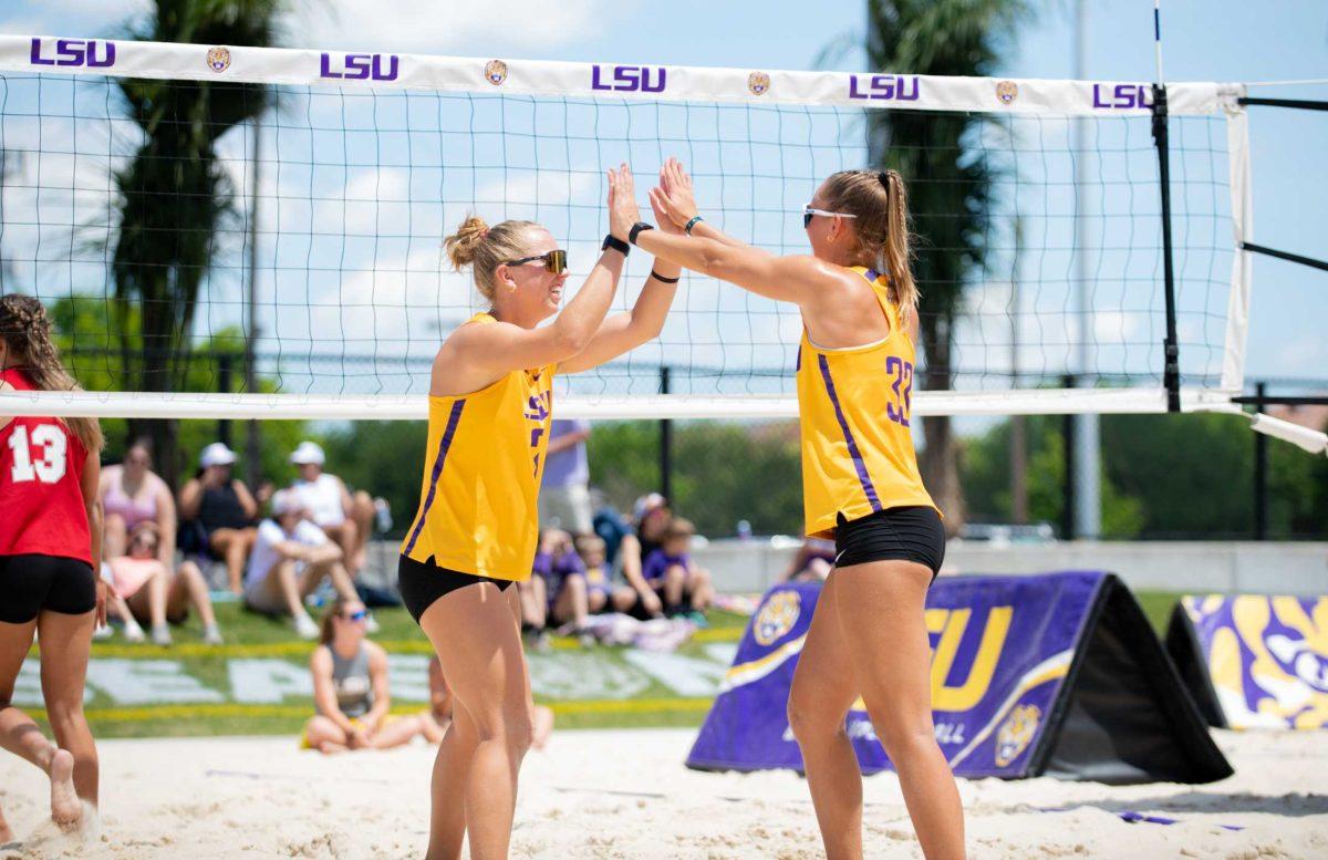 LSU beach volleyball sophomore Ella Larkin (3) and LSU beach volleyball senior Lara Boos (33) high five on Friday, April 14, 2023, during LSU&#8217;s 5-0 victory against Nicholls in Baton Rouge, La.