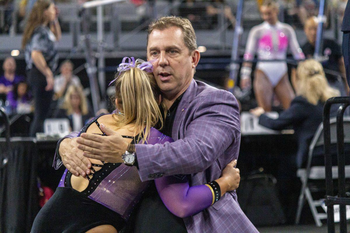 LSU gymnastics head coach Jay Clark hugs vault/ balance beam/ floor routine junior Sierra Ballard Saturday, April 15, 2023, after her floor routine during the 2023 Women&#8217;s National Collegiate Gymnastics Championship in the Dickies Arena in Fort Worth, Tx.