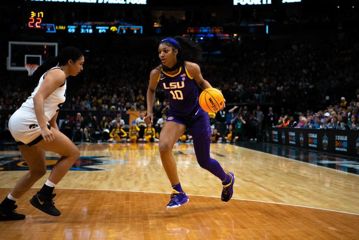 LSU women&#8217;s basketball sophomore forward Angel Reese (10) avoids her defender on Sunday, April 2, 2023, during LSU's 102-85 win against Iowa in the NCAA National Championship in the American Airlines Center in Dallas, Texas.