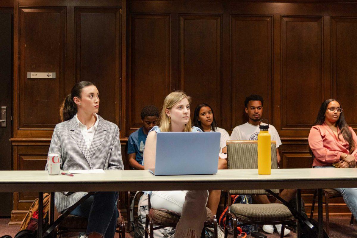 Innovate ticket heads Gigi Powers (left) and Anna Cate Strong (right) listen on Monday, Feb. 27, 2023, during a Student Government judicial proceeding in the LSU Student Union on Highland Road in Baton Rouge, La.