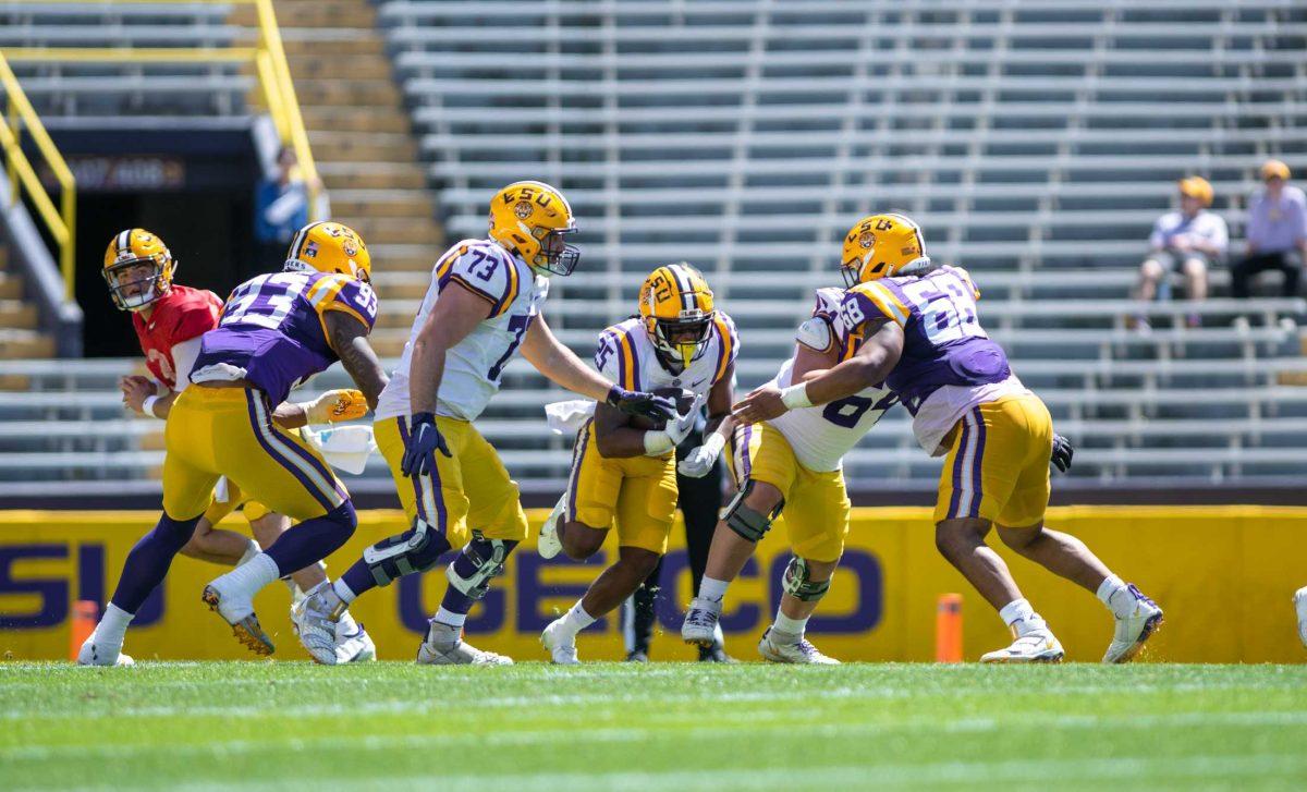 LSU football freshman running back Trey Holly (25) attempts to run through the defense on Saturday, April 22, 2023, during LSU&#8217;s 32-32 tie during the spring game in Tiger Stadium in Baton Rouge, La.